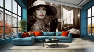 Beautiful woman in hat in luxury room. Wall mural