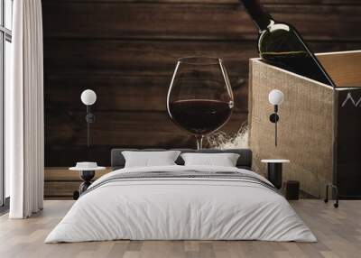 Bottle and glass of red wine on a wooden table Wall mural