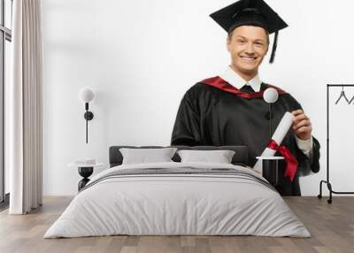 Cheerful young graduated student man isolated on white Wall mural