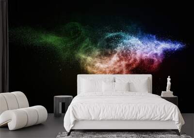 Colourful powder exploding isolated on black Wall mural