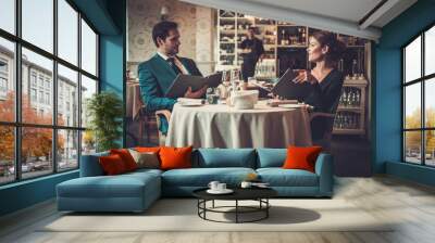 Couple reading menu in a restaurant Wall mural