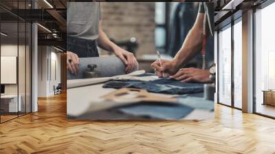 Fashion designer working in his studio Wall mural