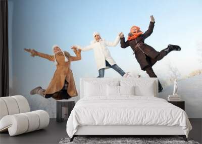 Happy girls jumping in the snow Wall mural