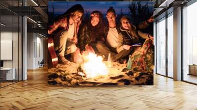 Hippie friends with guitar near bonfire Wall mural