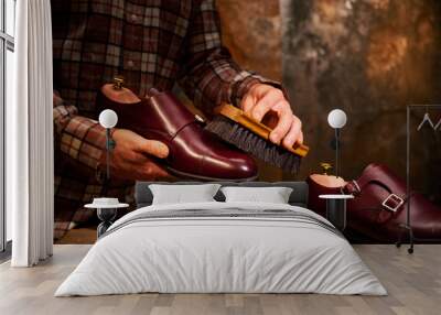 Man polishing leather shoes with brush Wall mural