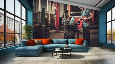 mechanic working on classic car engine in restoration workshop Wall mural