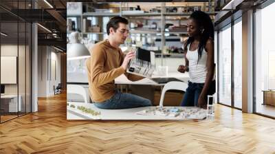 multiracial couple working in design and engineering architecture office. Wall mural