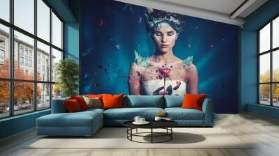 Winter beauty fantasy woman portrait. Beautiful young model girl and blast of frozen rose. Wall mural