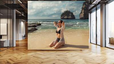 Woman walking on a beach at Diamond Bay, Nusa Penida island, Indonesia Wall mural