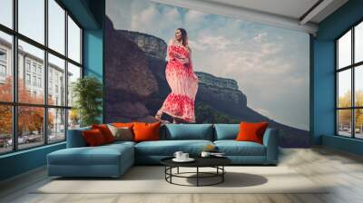 Young beautiful woman in red dress looking on mountains. Spain, Sant Roma de Sau. Wall mural