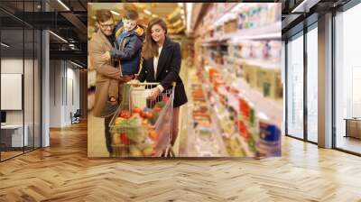 Young family in a grocery store Wall mural