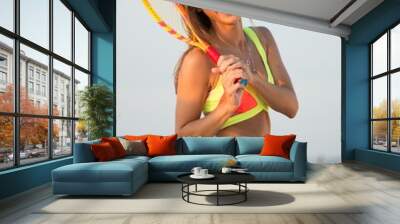 Young girl in swimming suit on a beach with racquet Wall mural