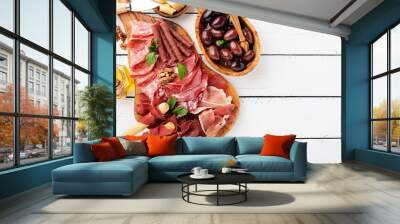 Antipasto platter cold meat with breadsticks, prosciutto, slices ham, beef jerky, salami and cheese platter on wooden board over rustic background.  Wall mural