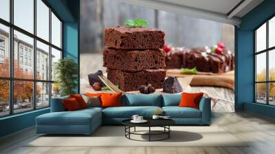 Chocolate brownie cake, dessert with nuts on wooden background. Wall mural