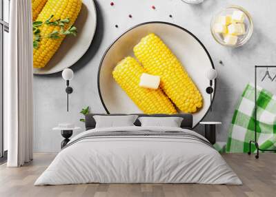 Cooked corn on the cob served with salt and butter. Light gray background. Top view Wall mural