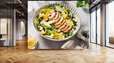 Easy Grilled Chicken breast salad with mango and avocado slices, sprinkled with walnuts and feta cheese. Spinach and arugula salad. Light gray background.  Wall mural