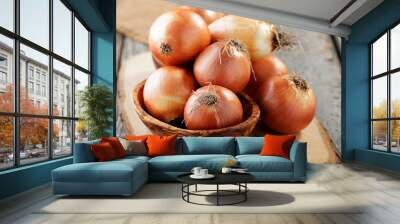 Fresh raw onions on wooden background.  Wall mural