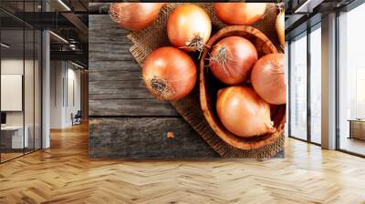 fresh raw onions on wooden background. top view. Wall mural