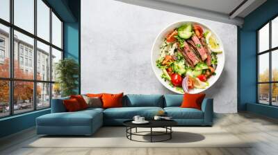 Fresh salad and creamy hummus are topped with veggies and perfectly grilled steak in this Mediterranean Steak Bowl. top view Wall mural