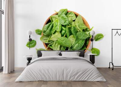 Fresh spinach leaves on wooden plate. Healthy vegan food. Top view. isolated on white background. Wall mural