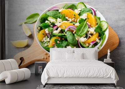 Fresh spinach salad with oranges, feta (ricotta) cheese, red onion and pine nuts . Wall mural