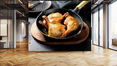 Freshly roasted duck legs confit in  pan,  black background Wall mural