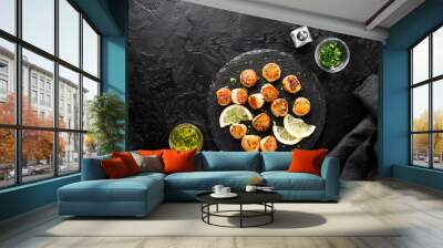 Grilled scallops with creamy lemon spicy sauce on black background. top view Wall mural