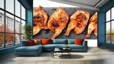 Halves of appetizing grilled juicy chicken with golden brown crust served with lemon slices,barbeque  sauce and rosemary. isolated on white background Wall mural