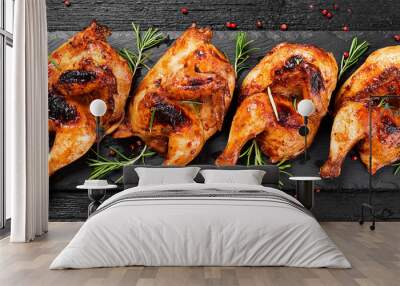 Halves of appetizing grilled juicy chicken with golden brown crust served with lemon slices,barbeque  sauce and rosemary. Wall mural