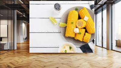 Homemade golden sweet corn cob with butter and salt on white table. top view. Wall mural