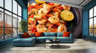 prawns shrimps roasted on pan with lemon and garlic on dark rustic background. top view. Wall mural