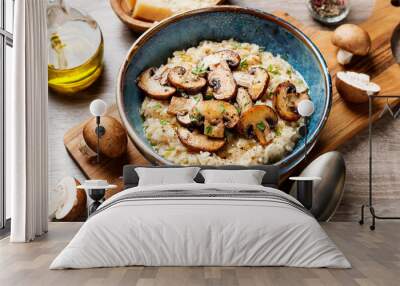 Risotto with brown champignon mushrooms on wooden background.  Wall mural