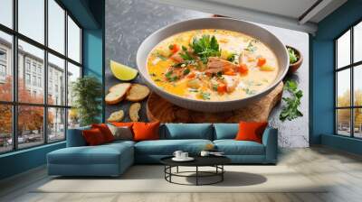 Salmon soup with cream, potatoes, carrots and parsley on gray background. Wall mural