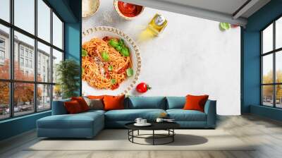 Tasty appetizing classic italian spaghetti pasta with tomato sauce, parmesan cheese and fresh basil leaves. Light gray stone background, top view. Space for text Wall mural