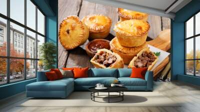 Traditional Australian Mini meat pies from shortbread dough on a wooden board over wooden background. Wall mural