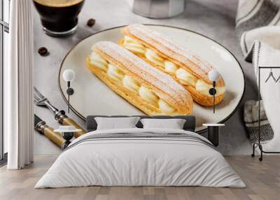 Traditional french eclairs filled with vanilla cream and powdered sugar. Wall mural