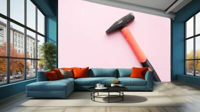 Orange hammer on pink background Wall mural