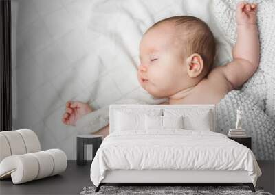 Sleeping newborn boy 2 months old with toy on white background close up and copy space Wall mural