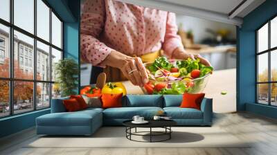 Photo of a woman preparing a salad in a kitchen Wall mural