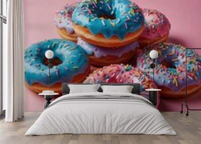 A blue glazed doughnut with rainbow sprinkles on top Wall mural