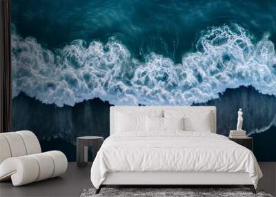 Aerial drone view or top view perspective photography of a beautiful transparent clear sea or ocean waves and foam splashing on the dark navvy blue or gray sand beach  Wall mural