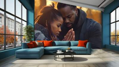 African American man and woman praying together outdoors in nature, sun rays in the background. Spiritual peace, Christian believer, Biblical hope, asking for forgiveness, male and female couple Wall mural