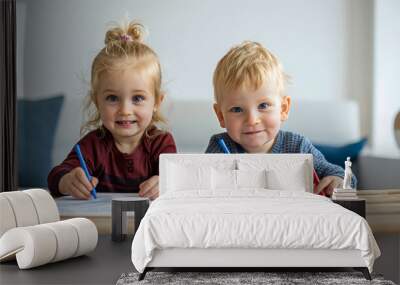 Brother and sister learning together, two children, toddler boy and girl holding pens, writing or drawing on paper on the table. Kindergarten pupil student education, nursery daycare kids Wall mural