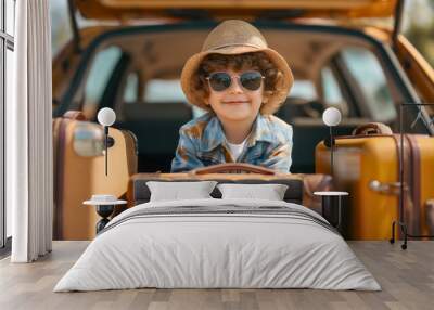 Happy little toddler boy wearing a straw hat, sunglasses and a tropical shirt, sitting in a car trunk on a sunny summer day, surrounded by suitcases, male preschool kid ready for family holiday travel Wall mural