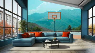 Nobody on an empty basketball playground court outdoors in the summer in the mountain range. Hoop with backboard, rim and net, recreation sport activity outside Wall mural