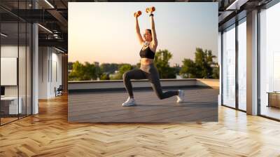 Sport girl doing  exercise on sunny summer day, on rooftop Wall mural