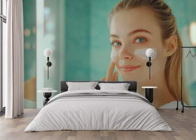 Young woman in bathroom applying face cream, part of her morning skincare routine, reflecting wellness and beauty care at home, a happy moment captured as she smiles at her reflection Wall mural