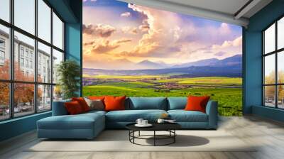 Picturesque green fields and meadow landscape. Panorama of Slovakia Tatras mountains in spring. Wall mural