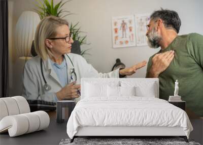 Doctor consulting with patient chest pain problems medical therapy concept. Male patient consulting a medical specialist at hospital. Chest pain and inflammatory heart disease Wall mural