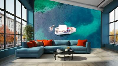 View of a private recreational boat with people swimming Wall mural